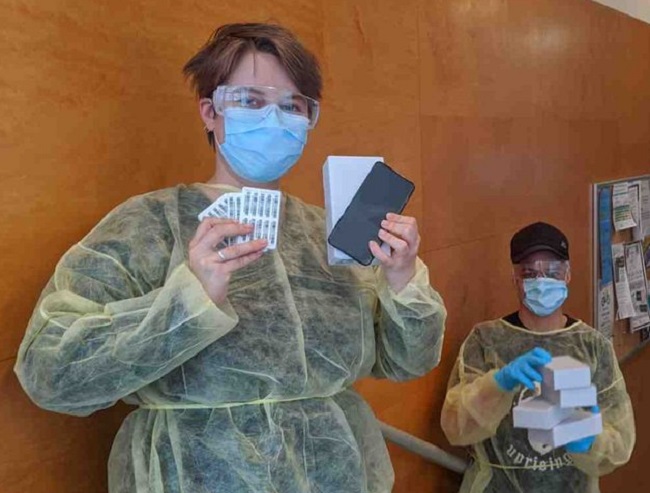 Staff at Guelph CHC pose with cellphones donated by Telus to help support outreach efforts and marginalized populations.