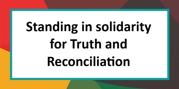 Graphic with multi-coloured border that reads: Standing in solidarity for Truth and Reconciliation