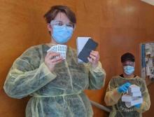 Staff at Guelph CHC pose with cellphones donated by Telus to help support outreach efforts and marginalized populations.