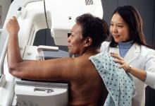 Black woman being screened for breast cancer with mammography.
